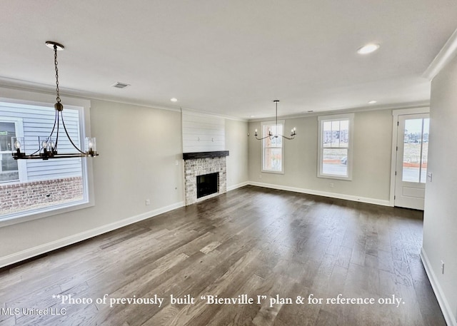 6674 Montclair Ave, Southaven, MS 38672 - unfurnished living room with crown molding, dark wood finished floors, recessed lighting, a notable chandelier, and baseboards