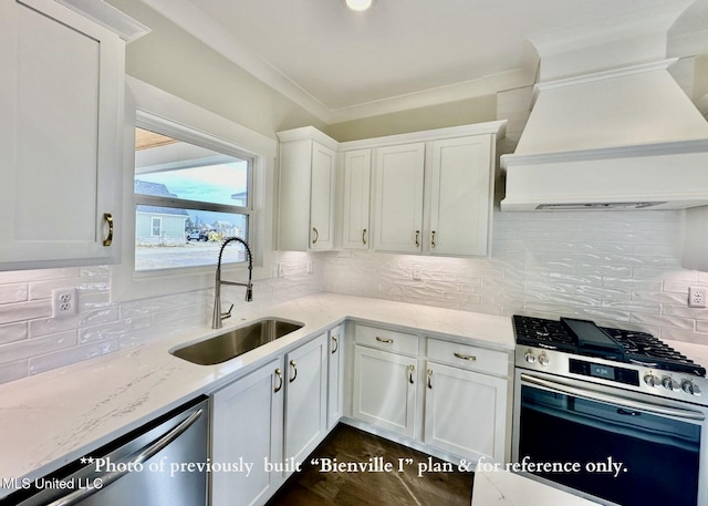 6674 Montclair Ave, Southaven, MS 38672 - kitchen with white cabinets, a sink, appliances with stainless steel finishes, light stone countertops, and custom range hood