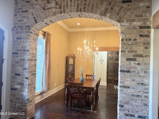 dining space featuring a notable chandelier, ornamental molding, and brick wall