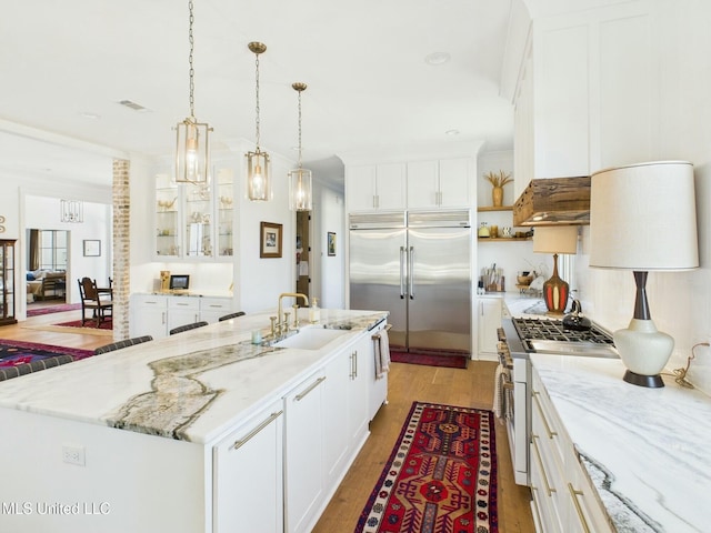 103 Honours Ln, Madison, MS 39110 - kitchen featuring white cabinetry, visible vents, wood finished floors, a sink, and high quality appliances