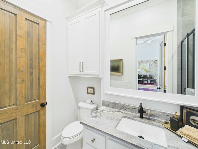 103 Honours Ln, Madison, MS 39110 - bathroom with toilet, vanity, ceiling fan, and a shower with door