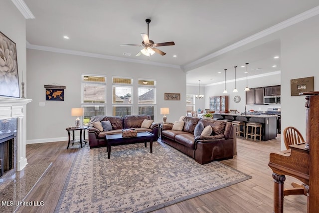 2006 Pelican Cir, Long Beach, MS 39560 - living area with a ceiling fan, a fireplace, wood finished floors, baseboards, and crown molding