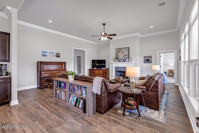 2006 Pelican Cir, Long Beach, MS 39560 - living room featuring a ceiling fan, baseboards, a fireplace, wood finished floors, and ornamental molding