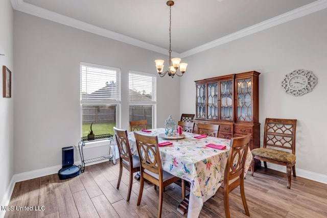 2006 Pelican Cir, Long Beach, MS 39560 - dining space with a chandelier, light wood finished floors, crown molding, and baseboards