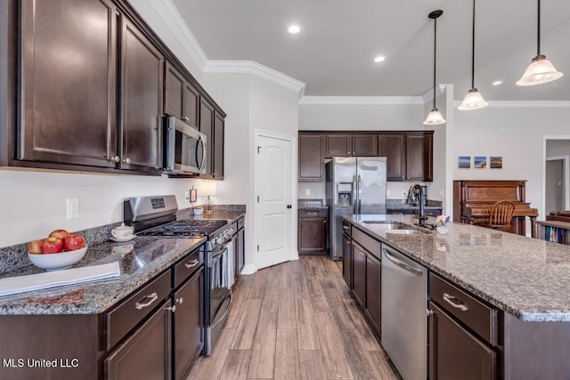 2006 Pelican Cir, Long Beach, MS 39560 - kitchen featuring stainless steel appliances, a sink, dark brown cabinetry, dark stone counters, and ornamental molding