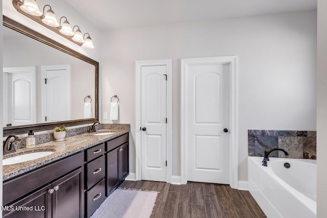 2006 Pelican Cir, Long Beach, MS 39560 - full bath with wood finished floors, a garden tub, double vanity, and baseboards