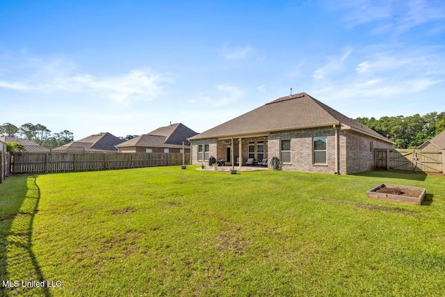 2006 Pelican Cir, Long Beach, MS 39560 - back of property featuring a patio, brick siding, roof with shingles, and a fire pit