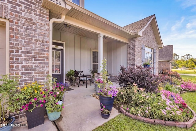 2006 Pelican Cir, Long Beach, MS 39560 - property entrance featuring brick siding, board and batten siding, a porch, and roof with shingles