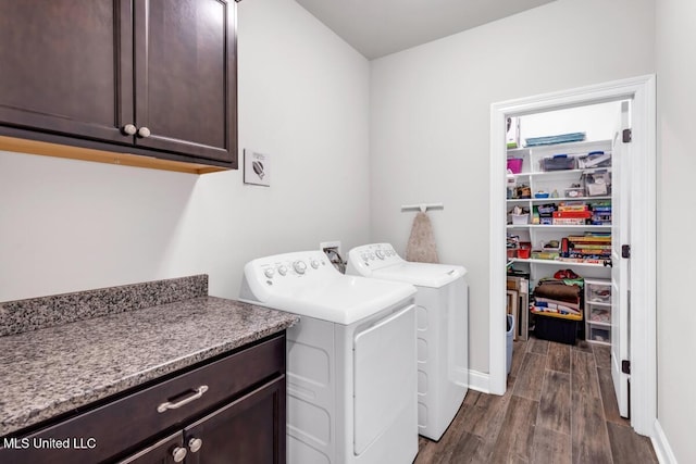 2006 Pelican Cir, Long Beach, MS 39560 - washroom featuring cabinet space, dark wood finished floors, washer and dryer, and baseboards