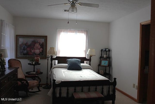 bedroom with visible vents, a ceiling fan, baseboards, and carpet floors