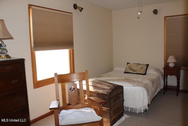 bedroom with baseboards and carpet floors