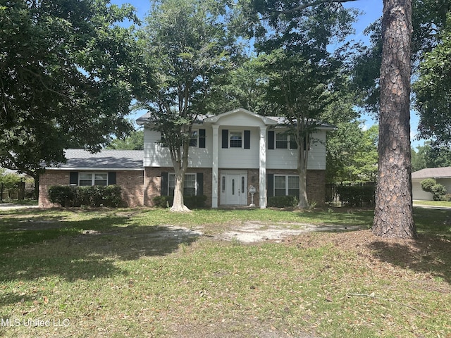 903 Westwood St, Pascagoula, MS 39567 - view of front facade featuring brick siding and a front yard
