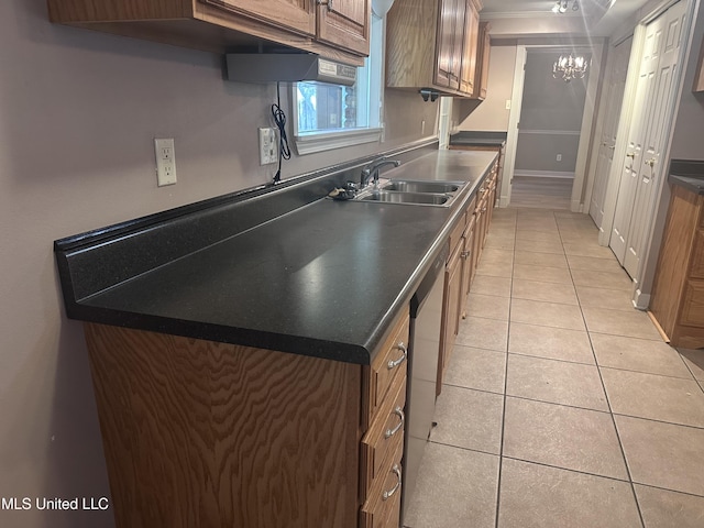 903 Westwood St, Pascagoula, MS 39567 - kitchen with brown cabinets, light tile patterned flooring, a sink, and dishwasher