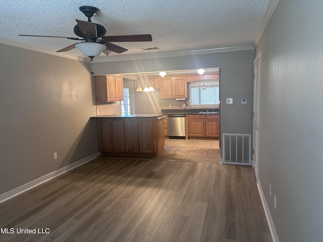 903 Westwood St, Pascagoula, MS 39567 - kitchen featuring stainless steel dishwasher, ornamental molding, a textured ceiling, and visible vents