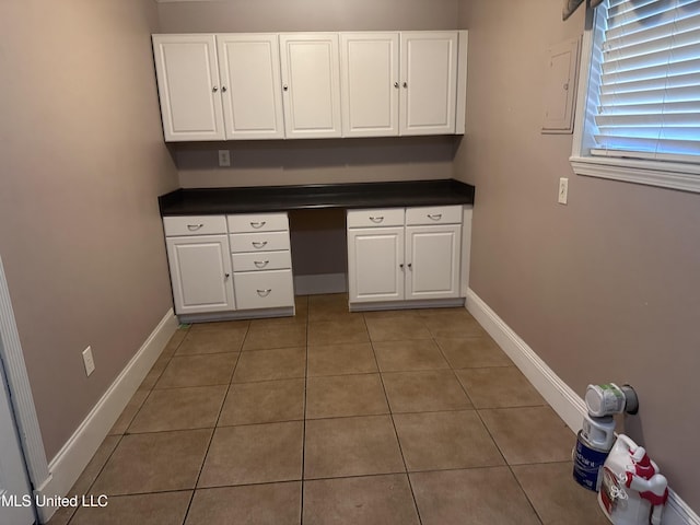 903 Westwood St, Pascagoula, MS 39567 - kitchen with light tile patterned floors, dark countertops, and white cabinetry