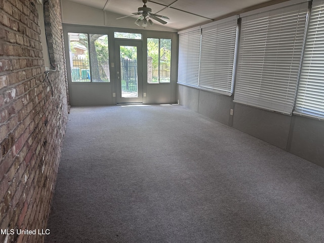 903 Westwood St, Pascagoula, MS 39567 - unfurnished room with ceiling fan, carpet flooring, and brick wall