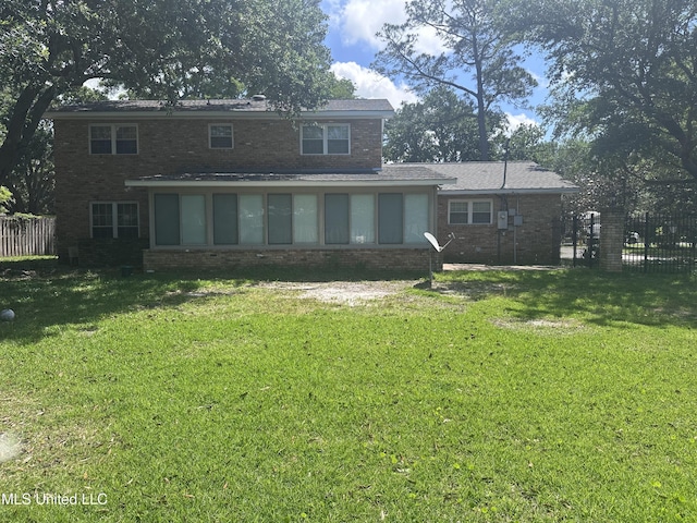 903 Westwood St, Pascagoula, MS 39567 - back of house featuring fence, a yard, and brick siding