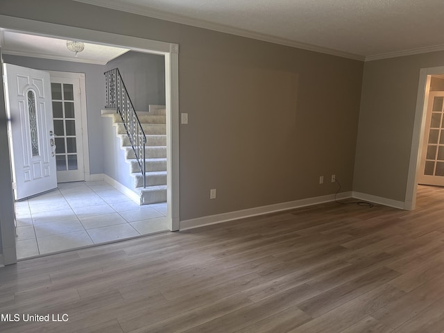 903 Westwood St, Pascagoula, MS 39567 - unfurnished room with baseboards, ornamental molding, wood finished floors, and stairway