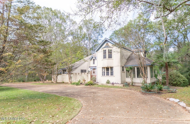 view of front of home with a sunroom