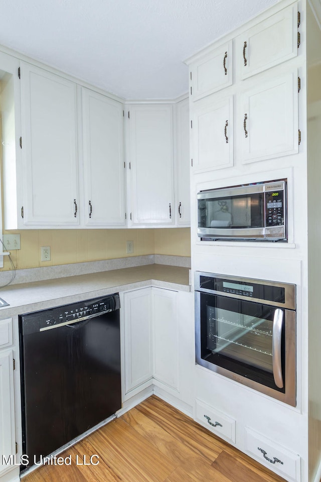 kitchen featuring light hardwood / wood-style floors, white cabinets, and stainless steel appliances