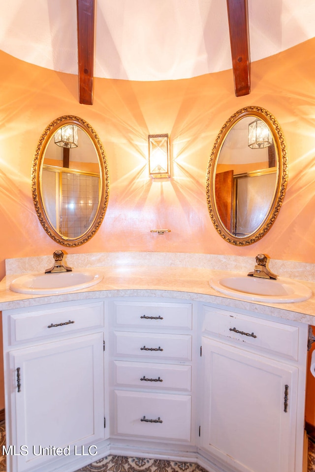 bathroom with beam ceiling and vanity