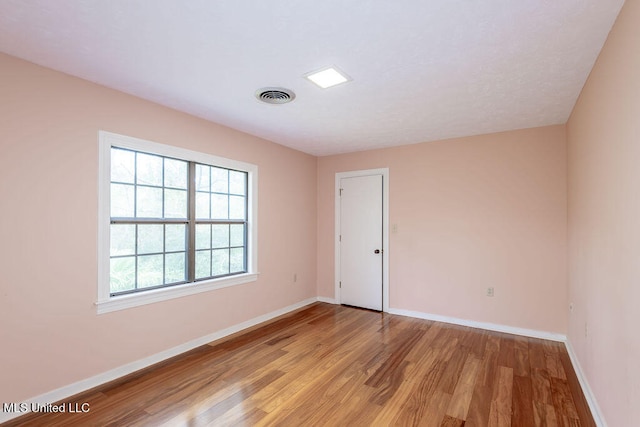 spare room with light hardwood / wood-style flooring