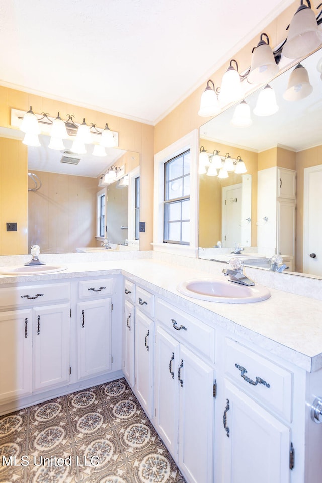 bathroom with vanity and ornamental molding