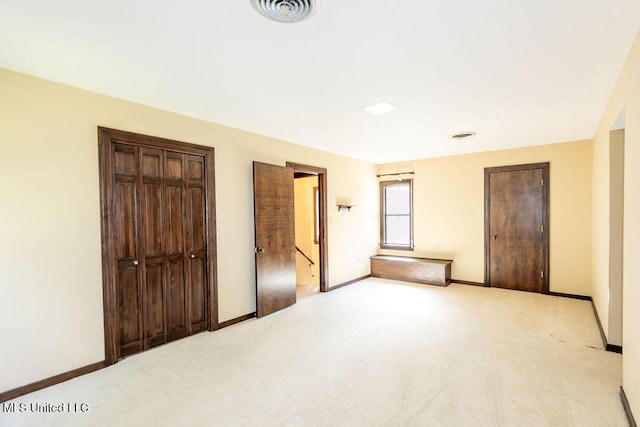 unfurnished bedroom featuring light carpet