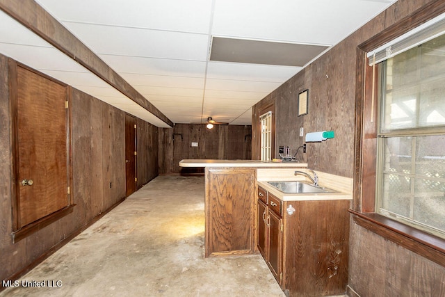 bar featuring wood walls and sink