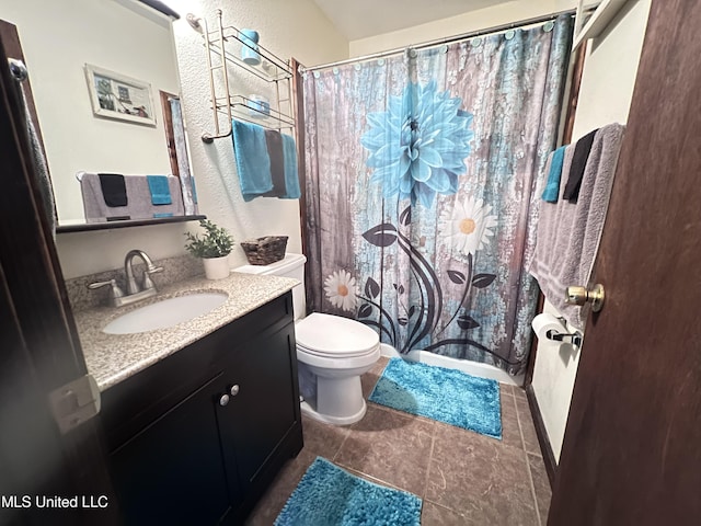 bathroom with toilet, vanity, and curtained shower