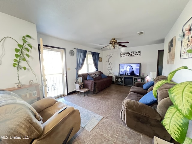 tiled living room featuring ceiling fan