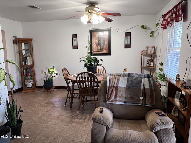 tiled dining space featuring ceiling fan