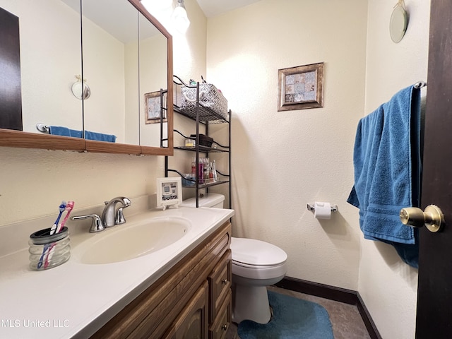 bathroom featuring toilet and vanity