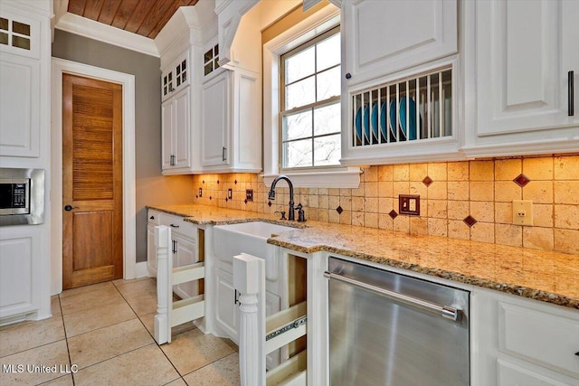 kitchen with glass insert cabinets, ornamental molding, stainless steel appliances, light tile patterned flooring, and white cabinetry