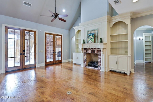 unfurnished living room featuring visible vents, french doors, a ceiling fan, and hardwood / wood-style flooring