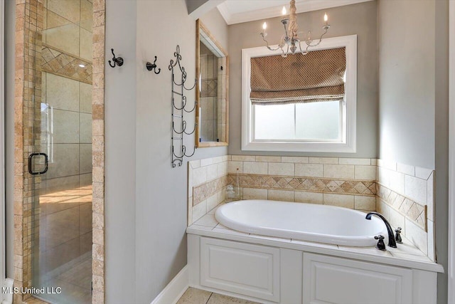 bathroom with an inviting chandelier, a bath, baseboards, and a shower stall