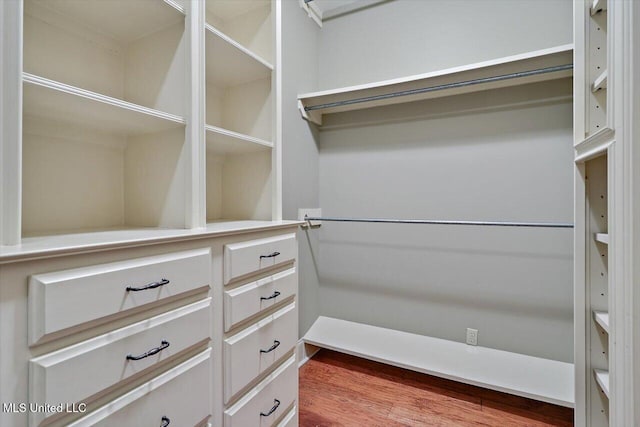 spacious closet with wood finished floors