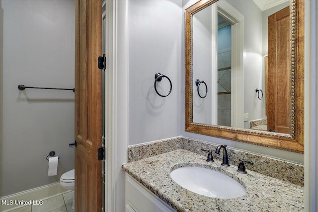 bathroom featuring tile patterned flooring, toilet, vanity, and baseboards