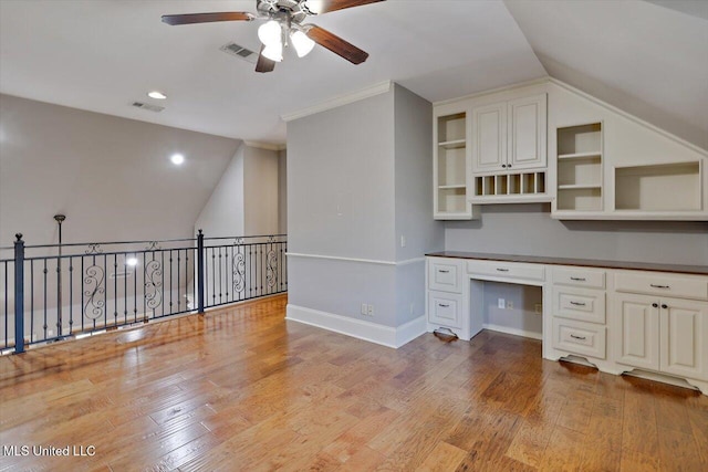 unfurnished office featuring ceiling fan, baseboards, light wood-type flooring, and built in study area