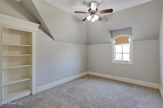 additional living space featuring carpet flooring, baseboards, ceiling fan, and vaulted ceiling