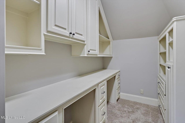 office with light carpet, baseboards, and lofted ceiling