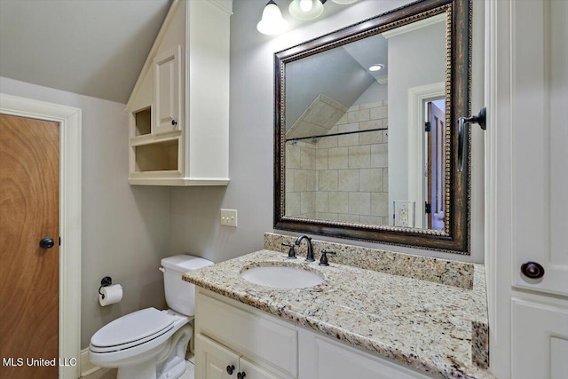 full bath with lofted ceiling, toilet, and vanity