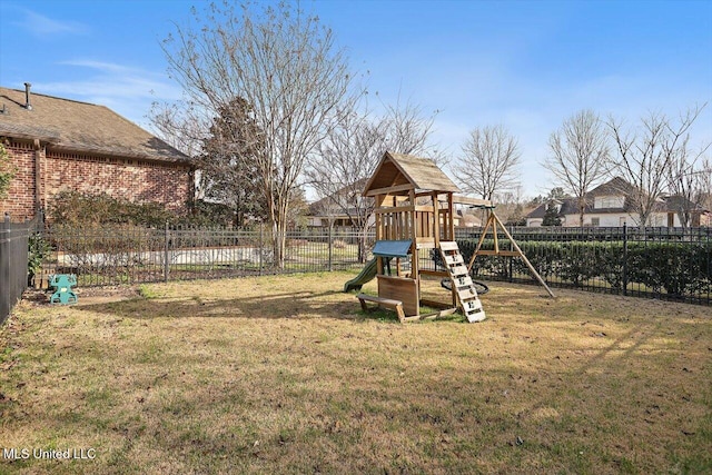 view of jungle gym with a lawn and fence