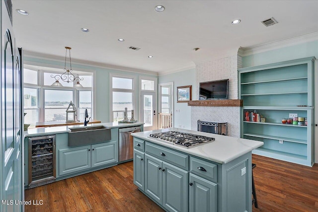 kitchen with sink, a kitchen island, stainless steel appliances, wine cooler, and dark hardwood / wood-style floors