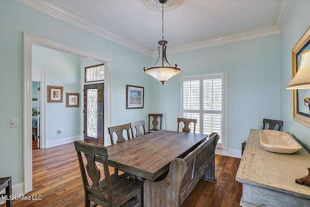 dining space with ornamental molding and dark hardwood / wood-style floors