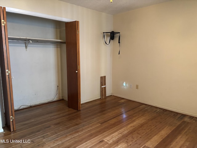 126 Faust Dr, Gulfport, MS 39503 - unfurnished bedroom featuring wood finished floors, a textured ceiling, baseboards, and a closet