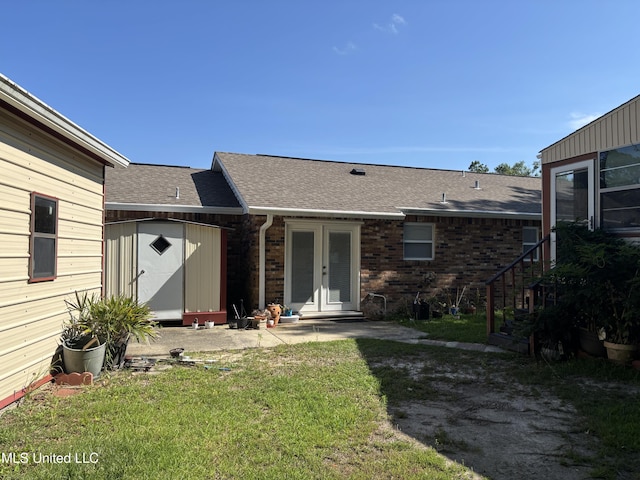 126 Faust Dr, Gulfport, MS 39503 - back of property with french doors, roof with shingles, and a lawn