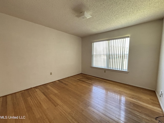 126 Faust Dr, Gulfport, MS 39503 - spare room featuring wood finished floors, a textured ceiling, and baseboards