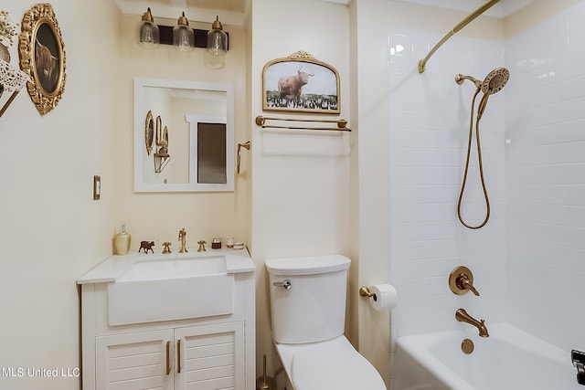 full bathroom with vanity, tiled shower / bath combo, and toilet