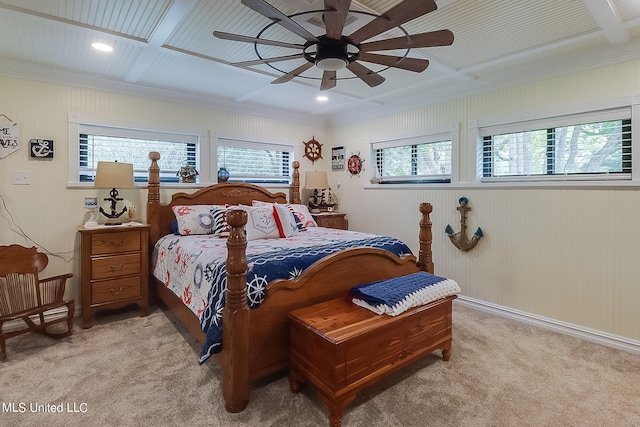 carpeted bedroom with multiple windows, ornamental molding, coffered ceiling, and ceiling fan